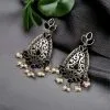 Elegant brass stone hanging stud earrings with intricate detailing, perfect for ethnic wear and festive occasions.