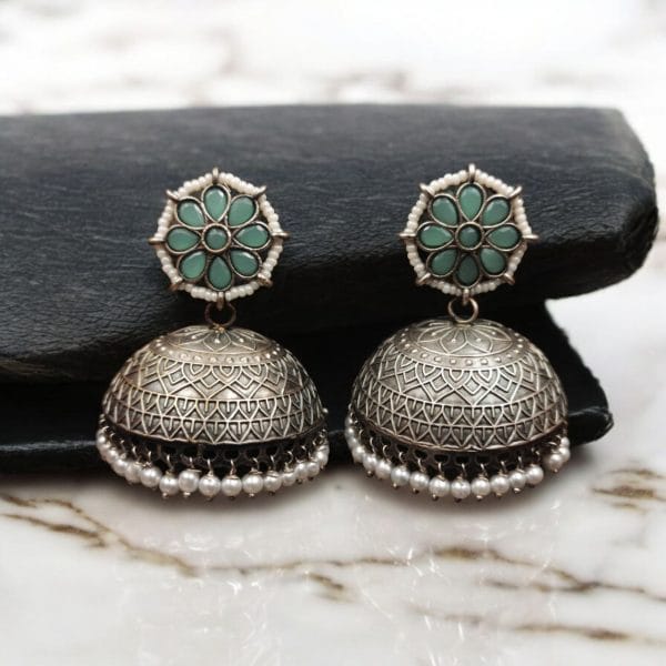 Handmade jhumka earrings with pearl and stone work, perfect for ethnic wear.