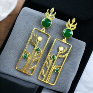 Premium gold plated stud earrings with an aesthetic leaf design and delicate stone detailing.