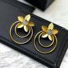 Elegant gold-plated half-circle flower earrings with floral and leaf design, adorned with sparkling stones for a stylish and contemporary look.