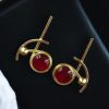 Elegant gold-plated Monalisa stone stud golden earrings for party wear.