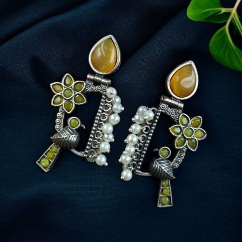 Traditional bird design oxidized silver replica bird earrings with pearl and stone work.
