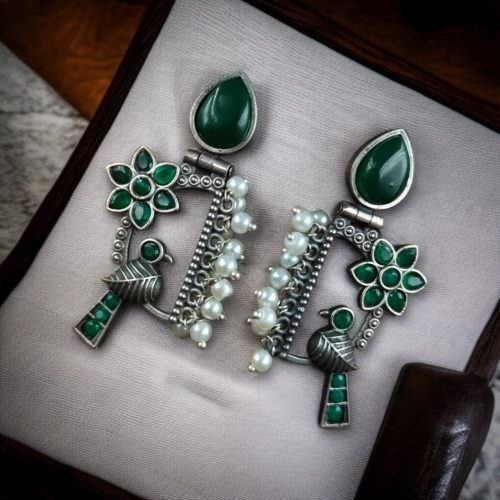 Traditional bird design oxidized silver replica bird earrings with pearl and stone work.