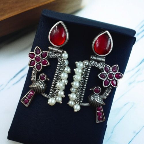 Traditional bird design oxidized silver replica bird earrings with pearl and stone work.