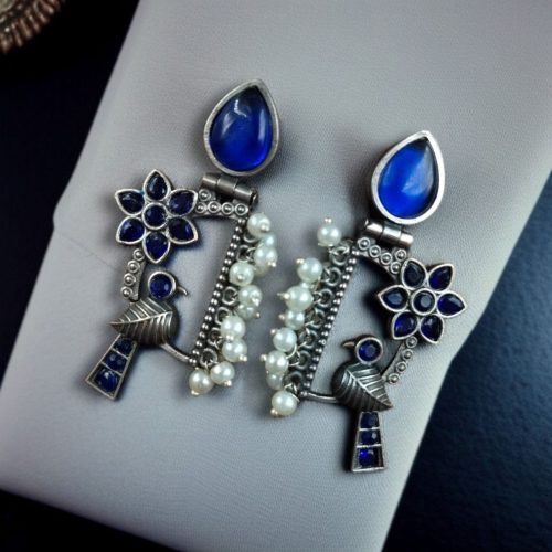 Traditional bird design oxidized silver replica bird earrings with pearl and stone work.