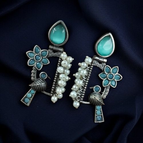 Traditional bird design oxidized silver replica bird earrings with pearl and stone work.