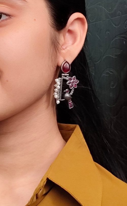 Traditional bird design oxidized silver replica bird earrings with pearl and stone work.