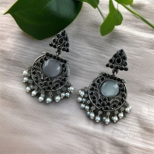 Designer floral earrings with silver replica finish, dangler stud style, and intricate stone detailing.