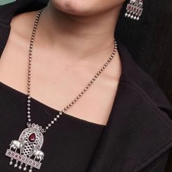 Silver oxidized Nandi pendant necklace with Monalisa stone and pearl work, featuring intricate detailing and antique finish.