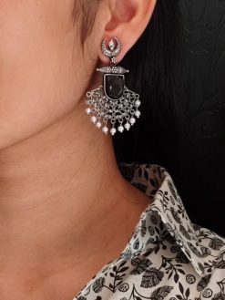 Oxidized half moon dangler earrings with floral design, pearl, and Monalisa stone.