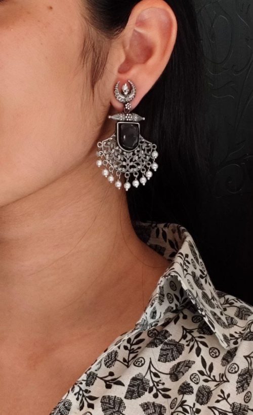 Oxidized half moon dangler earrings with floral design, pearl, and Monalisa stone.