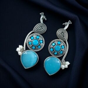 Traditional Unique Peacock Design Earrings in Oxidized Silver with Monalisa Stone and Pearl - color: "Aqua"