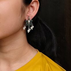 Silver plated peacock earrings with pearl and oxidized finish.