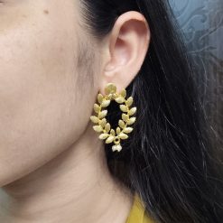 Golden leaf earrings with pearl accents for daily ethnic wear.