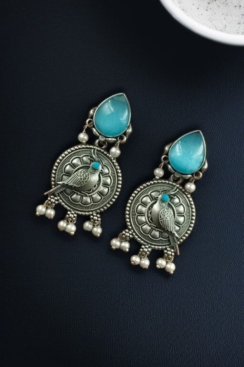 Antique silver parrot dangler earrings with Monalisa stone and pearl accents.