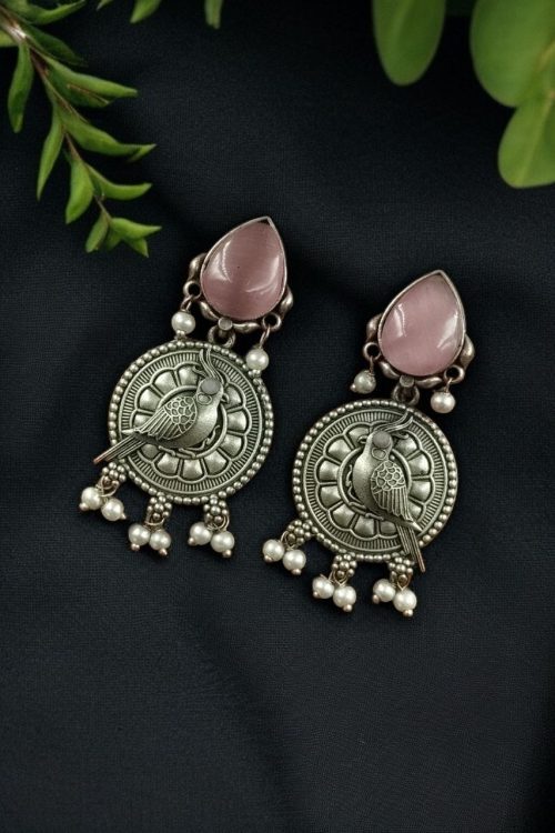 Antique silver parrot dangler earrings with Monalisa stone and pearl accents.