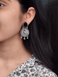 Antique silver parrot dangler earrings with Monalisa stone and pearl accents.