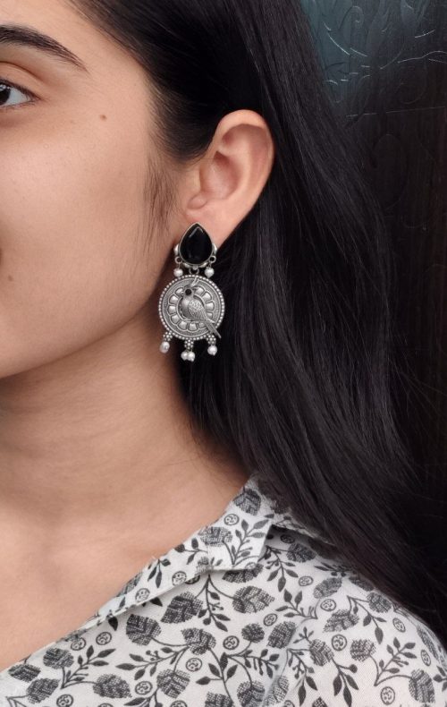 Antique silver parrot dangler earrings with Monalisa stone and pearl accents.