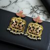 Gold plated floral art dangler earrings with stone and pearl work