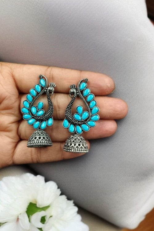 Antique oxidised peacock jhumki earrings in German silver with stone work