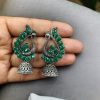 Antique oxidised peacock jhumki earrings in German silver with stone work