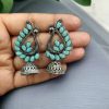 Antique oxidised peacock jhumki earrings in German silver with stone work