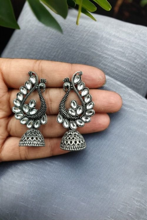 Antique oxidised peacock jhumki earrings in German silver with stone work