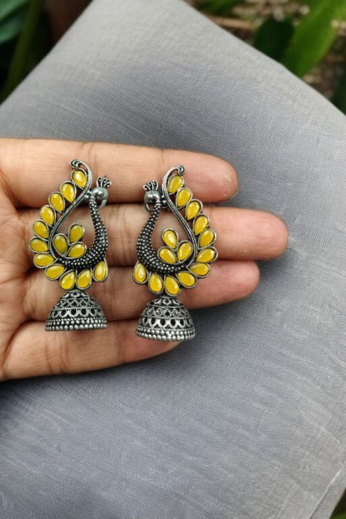 Antique oxidised peacock jhumki earrings in German silver with stone work
