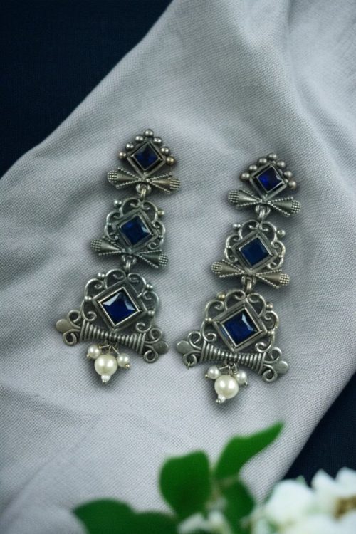 Floral 3-layer dangler earrings with pearls and stone accents.