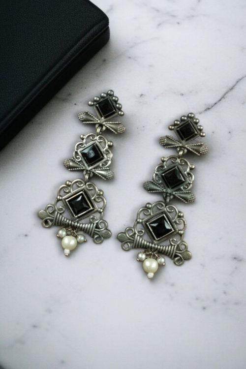 Floral 3-layer dangler earrings with pearls and stone accents.