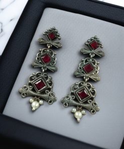 Floral 3-layer dangler earrings with pearls and stone accents.