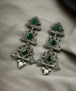 Floral 3-layer dangler earrings with pearls and stone accents.