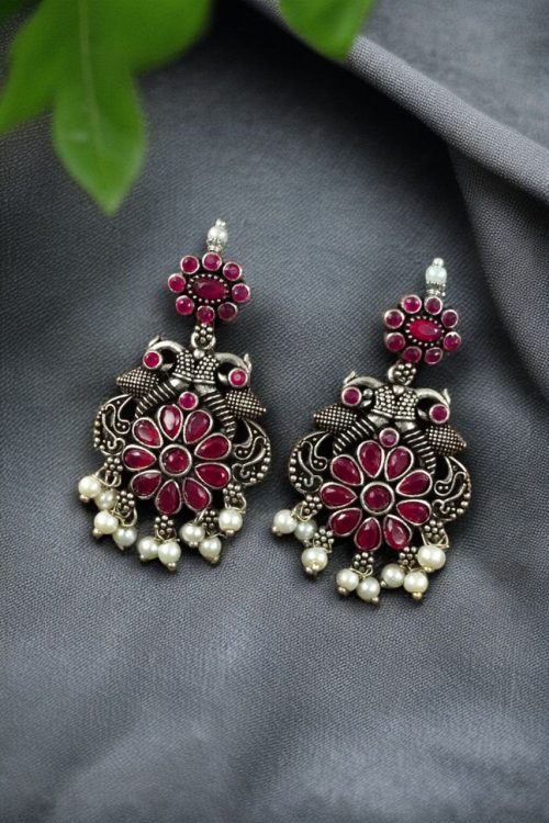 Silver plated peacock dangler earrings with stone and pearl detailing