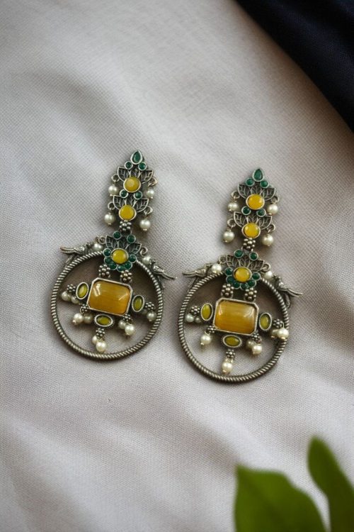 Silver look-alike bird earrings with stone and pearl work in oxidized finish.