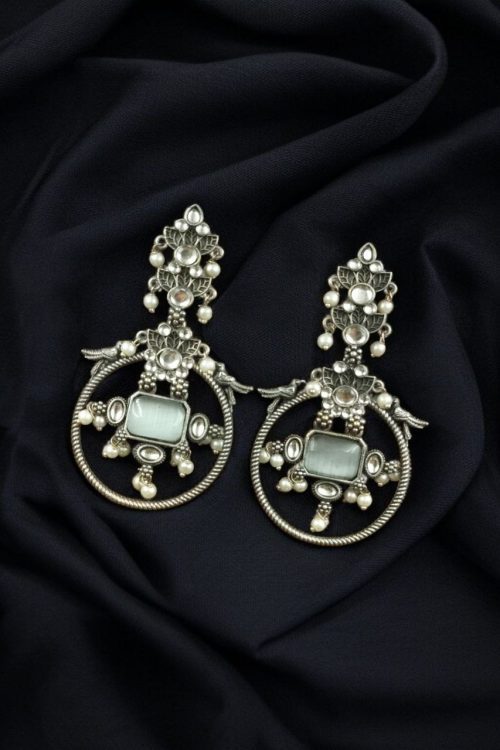 Silver look-alike bird earrings with stone and pearl work in oxidized finish.