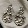 Silver look-alike bird earrings with stone and pearl work in oxidized finish.