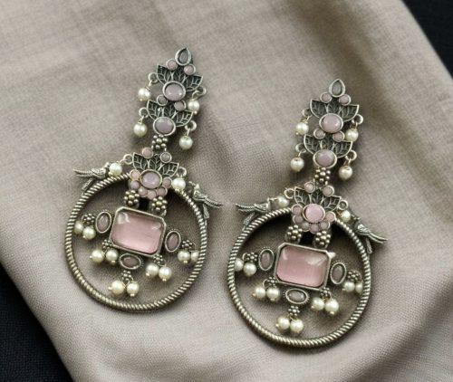 Silver look-alike bird earrings with stone and pearl work in oxidized finish.