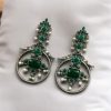 Silver look-alike bird earrings with stone and pearl work in oxidized finish.