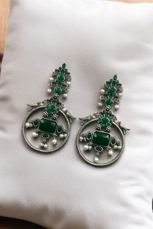 Silver look-alike bird earrings with stone and pearl work in oxidized finish.
