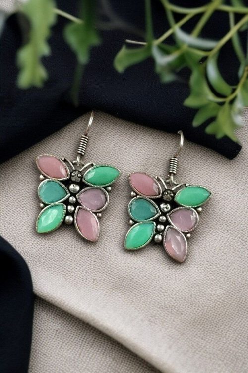 Oxidized butterfly hook earrings with stone work in silver plated finish.