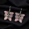 Oxidized butterfly hook earrings with stone work in silver plated finish.