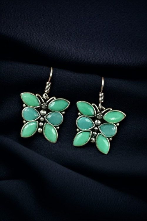 Oxidized butterfly hook earrings with stone work in silver plated finish.
