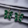 Oxidized butterfly hook earrings with stone work in silver plated finish.
