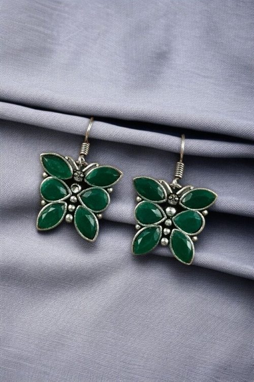 Oxidized butterfly hook earrings with stone work in silver plated finish.