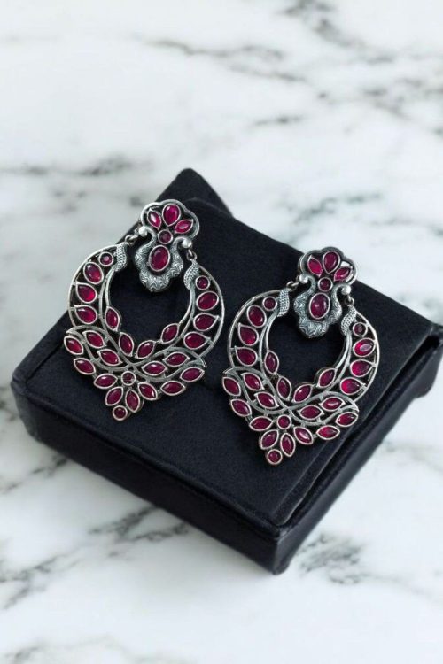 Oxidized silver replica dangler earrings with peacock design and stone work.