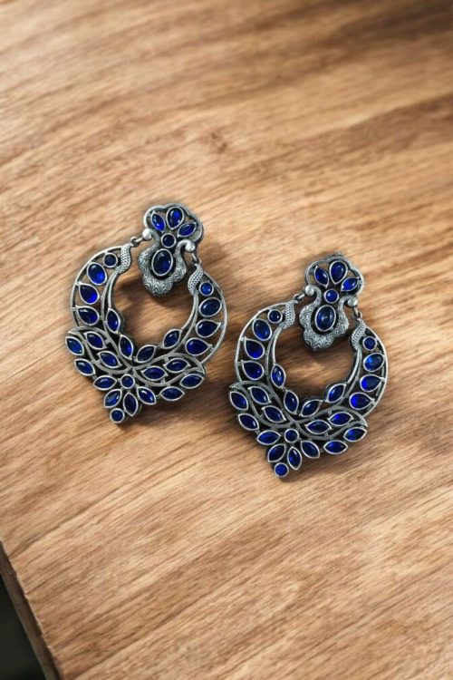 Oxidized silver replica dangler earrings with peacock design and stone work.