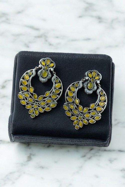 Oxidized silver replica dangler earrings with peacock design and stone work.