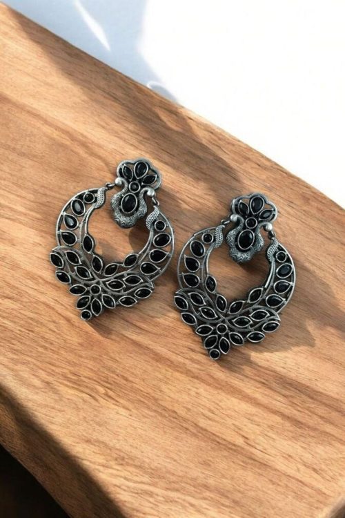 Oxidized silver replica dangler earrings with peacock design and stone work.