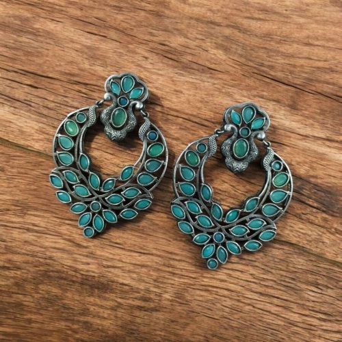 Oxidized silver replica stone dangler earrings with peacock design and stone work.