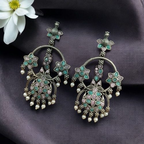Ethnic peacock earrings with oxidized silver replica finish, stone and pearl work.